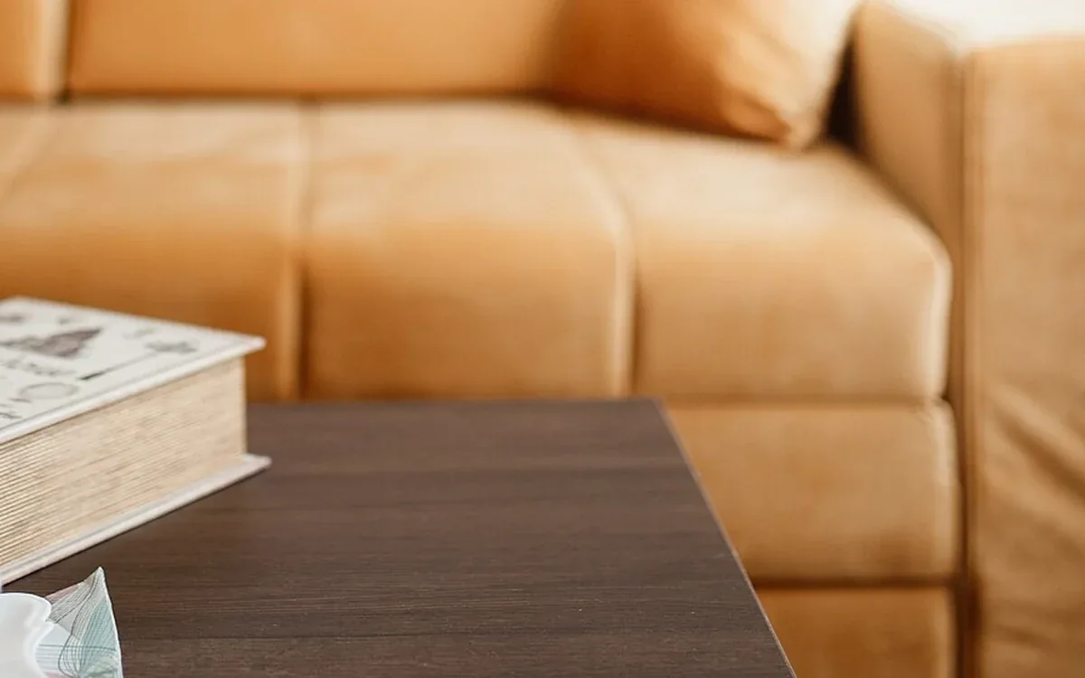 Mustard-colored sofa cushions sit against a pale wall