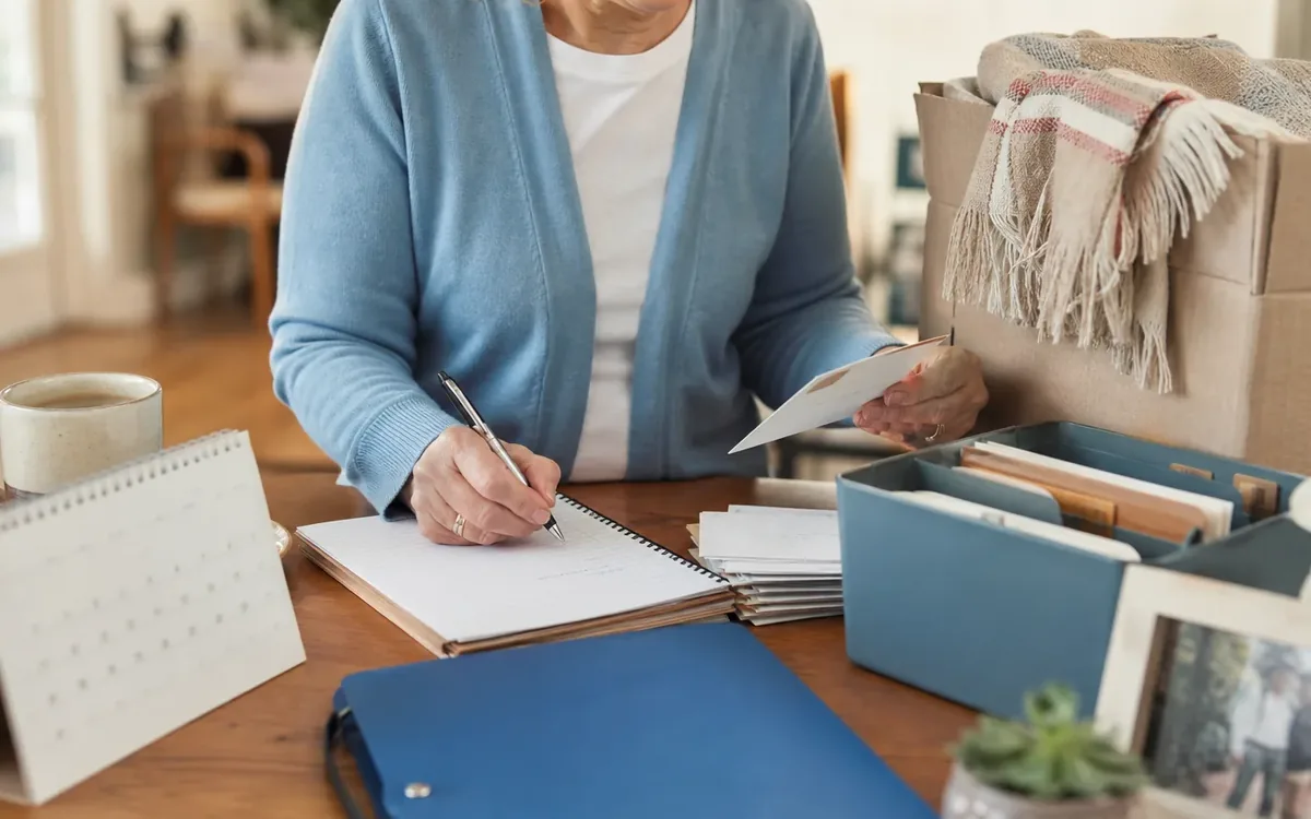 Hands organizing household items while planning step 1: capture every calendar source before changing anything